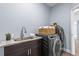 Convenient laundry room with granite countertops, undermount sink, and a modern washer and dryer at 3427 Harborside Ct, Kissimmee, FL 34746