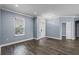 Bright living room with hardwood floors, large window, and a white front door with sidelights at 3427 Harborside Ct, Kissimmee, FL 34746