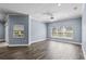 Bright living room featuring tile flooring, large windows, and ceiling fan with light fixture at 3427 Harborside Ct, Kissimmee, FL 34746
