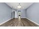 Spacious living room with hardwood floors, recessed lighting, and an open doorway to another room at 3427 Harborside Ct, Kissimmee, FL 34746