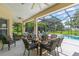 Covered and screened patio featuring comfortable seating and an outdoor dining area overlooking the backyard at 3427 Harborside Ct, Kissimmee, FL 34746