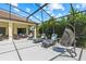 Relaxing screened-in patio featuring comfortable lounge furniture and hanging swing chairs at 3427 Harborside Ct, Kissimmee, FL 34746