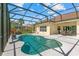 Screened-in pool area featuring a unique shaped pool and a covered patio with an outdoor dining set at 3427 Harborside Ct, Kissimmee, FL 34746