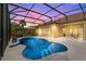 Screened-in pool area featuring a unique shaped pool and a covered patio with an outdoor dining set at 3427 Harborside Ct, Kissimmee, FL 34746