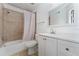 Bright bathroom features tiled shower-tub, white vanity with sink and mirror at 437 Fountainhead Cir # 283, Kissimmee, FL 34741