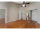 Bedroom featuring wood floors, a closet with mirrored doors, and a doorway to the bathroom at 437 Fountainhead Cir # 283, Kissimmee, FL 34741