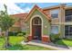 Charming condo exterior with a green and orange entrance and meticulously kept lawn at 437 Fountainhead Cir # 283, Kissimmee, FL 34741