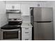 Updated kitchen featuring stainless steel appliances and sleek white cabinets at 437 Fountainhead Cir # 283, Kissimmee, FL 34741