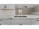 Modern kitchen counter boasting a stainless steel sink and marble countertops at 437 Fountainhead Cir # 283, Kissimmee, FL 34741