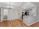 Bright kitchen featuring laminate floors, white cabinetry, and modern appliances at 437 Fountainhead Cir # 283, Kissimmee, FL 34741