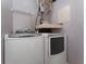 Convenient laundry area with washer and dryer, featuring overhead storage and utility connections at 437 Fountainhead Cir # 283, Kissimmee, FL 34741