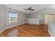 Cozy living space with wood floors, a fan, and a large window at 437 Fountainhead Cir # 283, Kissimmee, FL 34741