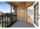 Screened-in lanai features a view, textured walls, an exterior light fixture, and a door into the home at 437 Fountainhead Cir # 283, Kissimmee, FL 34741