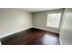 Bedroom with hardwood floors and a window overlooking the neighborhood at 4728 Walden Cir # 32, Orlando, FL 32811
