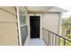 Exterior shot of unit's front door, showing the unit number and the surrounding structure at 4728 Walden Cir # 32, Orlando, FL 32811