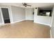 Bright living room featuring tile floors, ceiling fan, and a view into the kitchen at 4728 Walden Cir # 32, Orlando, FL 32811