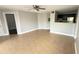 Bright living room featuring tile floors, ceiling fan, and a view into the kitchen at 4728 Walden Cir # 32, Orlando, FL 32811