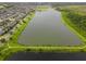 Gorgeous aerial view of a lake community with lush landscaping and walking trails at 4800 Riverwalk Dr, St Cloud, FL 34771