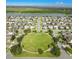 Stunning aerial view of a Gathering friendly community with a central park and lake views at 4800 Riverwalk Dr, St Cloud, FL 34771
