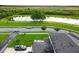 A beautiful aerial view features lush landscaping and a serene pond view at 4800 Riverwalk Dr, St Cloud, FL 34771