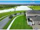 The aerial view highlights the home's desirable location with lush greenery and a pond at 4800 Riverwalk Dr, St Cloud, FL 34771