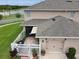 Aerial view of a townhome with a fenced patio and close proximity to community lake at 4800 Riverwalk Dr, St Cloud, FL 34771