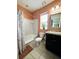 Cozy bathroom with a shower-tub combo, white tile, and a stylish vanity at 4800 Riverwalk Dr, St Cloud, FL 34771