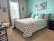 Bright bedroom featuring carpet floors, a large window, and stylish decor at 4800 Riverwalk Dr, St Cloud, FL 34771