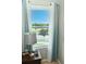 Cozy bedroom featuring a window with tranquil view, with blue and white curtains at 4800 Riverwalk Dr, St Cloud, FL 34771