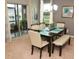 Elegant dining room with a modern table and chairs, adjacent to sliding doors at 4800 Riverwalk Dr, St Cloud, FL 34771