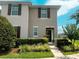 Inviting two-story townhome featuring manicured landscaping and a welcoming entrance at 4800 Riverwalk Dr, St Cloud, FL 34771