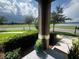 Home with serene lake view, lush landscaping and a glimpse of the front porch at 4800 Riverwalk Dr, St Cloud, FL 34771