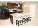 Modern kitchen with stainless steel appliances, granite countertops, and a spacious island at 4800 Riverwalk Dr, St Cloud, FL 34771