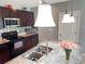 Modern kitchen featuring stainless steel appliances, granite countertops and dark wood cabinets at 4800 Riverwalk Dr, St Cloud, FL 34771