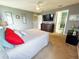 Relaxing main bedroom with soft carpet, ceiling fan, ensuite bathroom, and neutral color palette at 4800 Riverwalk Dr, St Cloud, FL 34771