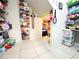Spacious walk-in pantry with tiled floor and organized shelving for ample storage at 4800 Riverwalk Dr, St Cloud, FL 34771