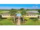 The community pool is nestled near a pond and palm trees in a tropical paradise at 4800 Riverwalk Dr, St Cloud, FL 34771