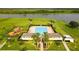 An aerial view showcases a community pool, palm trees, and a playground at 4800 Riverwalk Dr, St Cloud, FL 34771
