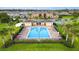 The community pool is surrounded by palm trees, lounge chairs, and lush landscaping at 4800 Riverwalk Dr, St Cloud, FL 34771