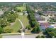 This high aerial view focuses on the back of the house, which has a lovely yard and is backed up by tall mature trees at 4903 Santa Clara Dr, Orlando, FL 32837