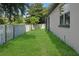 Well-maintained backyard featuring lush green grass and a white wooden fence at 4903 Santa Clara Dr, Orlando, FL 32837
