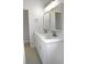 Bright bathroom featuring double sinks, quartz countertops and modern lighting fixture at 4903 Santa Clara Dr, Orlando, FL 32837