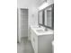 Bright bathroom featuring double sinks, quartz countertops and modern shelving unit at 4903 Santa Clara Dr, Orlando, FL 32837