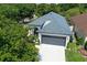 Aerial front view of a modern single-story home with a two-car garage and lush landscaping at 4903 Santa Clara Dr, Orlando, FL 32837