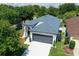Aerial view of a well-maintained single-story home with a two-car garage and mature trees at 4903 Santa Clara Dr, Orlando, FL 32837