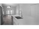 Bright, modern kitchen with stainless steel sink, white cabinets and countertops, view to pool at 4903 Santa Clara Dr, Orlando, FL 32837