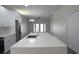 An open concept kitchen with white cabinets, stainless steel refrigerator, and an island with a sink at 4903 Santa Clara Dr, Orlando, FL 32837