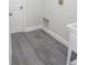 Clean laundry room with gray vinyl plank flooring, neutral paint, and new appliances at 4903 Santa Clara Dr, Orlando, FL 32837