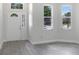Bright living room showcasing gray floors, white walls, and a view from several windows at 4903 Santa Clara Dr, Orlando, FL 32837