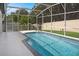 Enclosed pool with pristine blue water and a screened-in lanai offers a relaxing outdoor retreat at 4903 Santa Clara Dr, Orlando, FL 32837